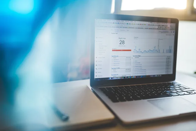 Laptop displaying Google Analytics in a modern workspace, highlighting digital analytics and technology. Ecommerce platform attribution checks: Google Analytics, Attribution and PECR