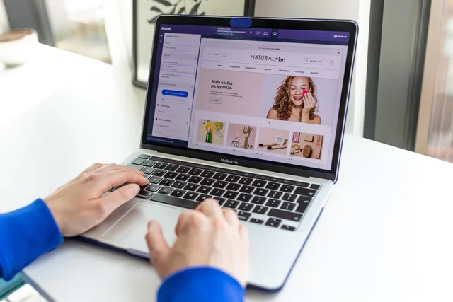 Hands typing on a laptop with an e-commerce website open, showcasing online shopping. Three ecommerce platform candidates for an England shop: Shopify Basic, Square Online Free and WooCommerce