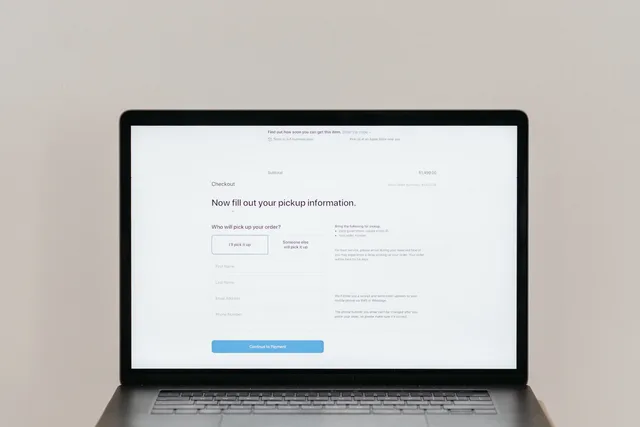 A laptop displaying an online checkout form, highlighting technology and e-commerce. How to structure an ecommerce platform cost register